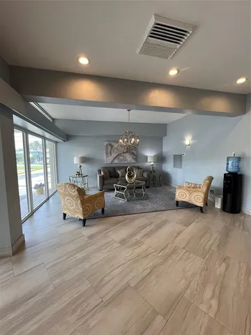 a living room with furniture and a chandelier