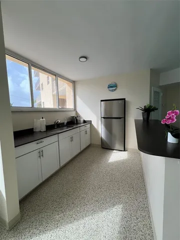 a kitchen with stainless steel appliances a stove a sink and a microwave