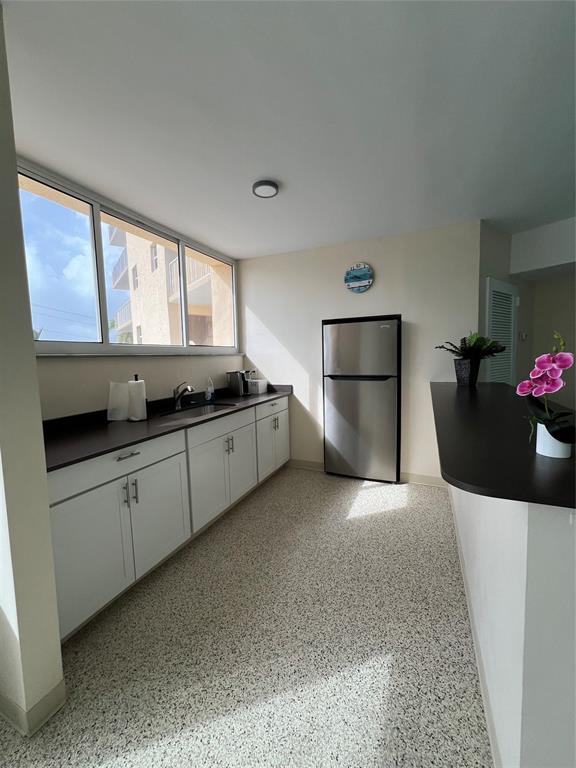 1200 Hibiscus Avenue, Unit 1501 Pompano Beach, FL 33062 - Photo 26 of 40 a kitchen with stainless steel appliances a stove a sink and a microwave