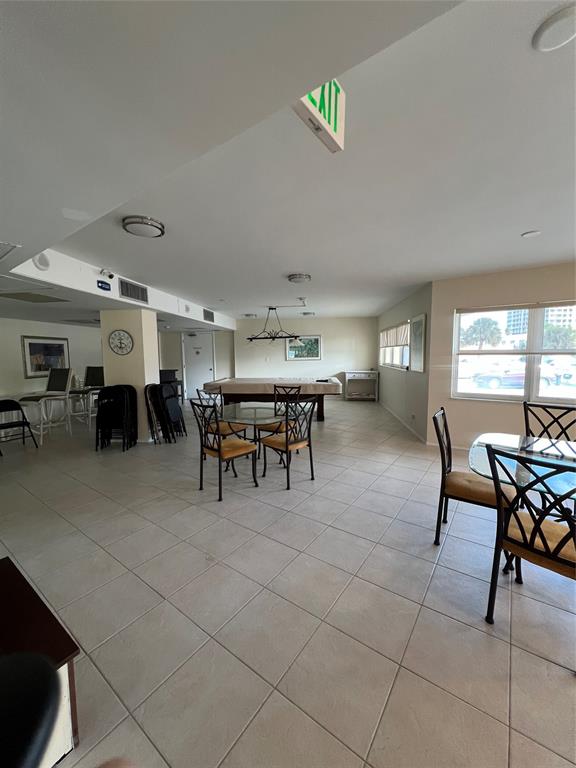 1200 Hibiscus Avenue, Unit 1501 Pompano Beach, FL 33062 - Photo 28 of 40 a big room with chairs and a window