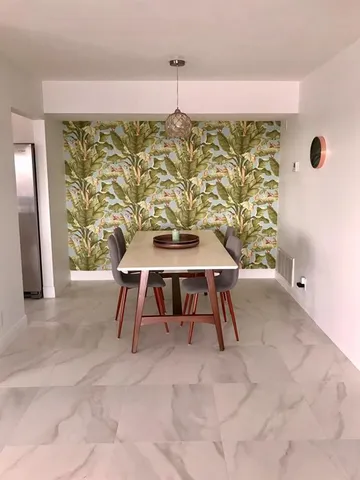 a dining room with furniture and window