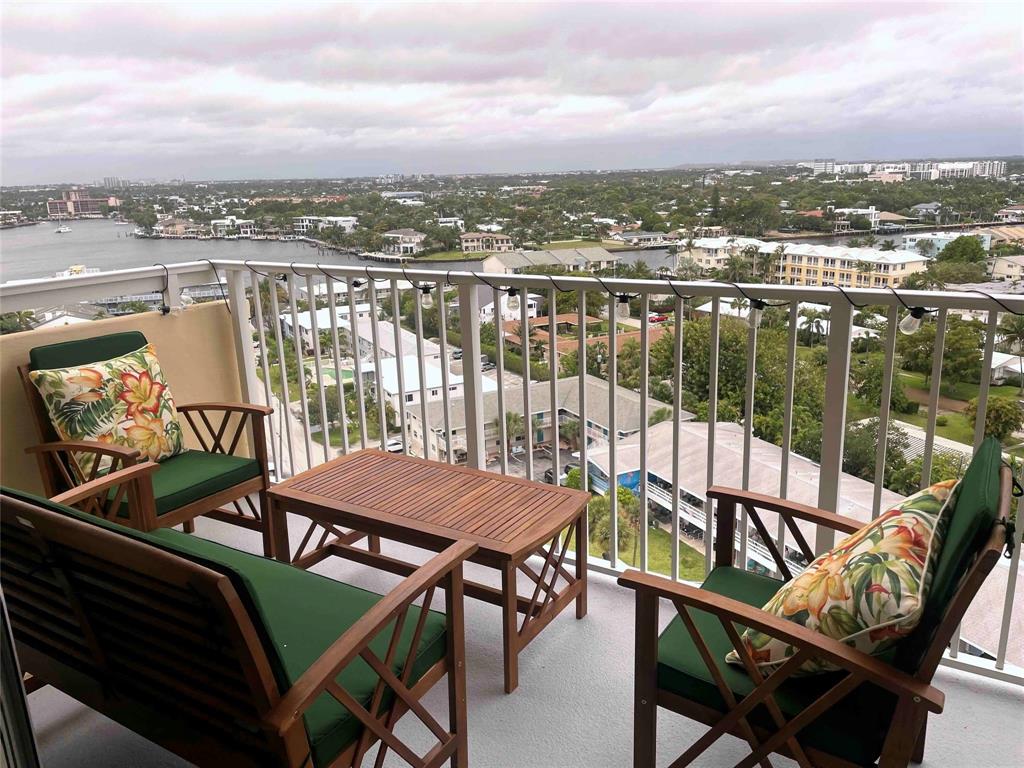 1200 Hibiscus Avenue, Unit 1501 Pompano Beach, FL 33062 - Photo 33 of 40 a view of a balcony with an outdoor seating