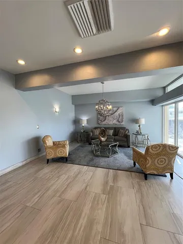 a living room with furniture and a chandelier