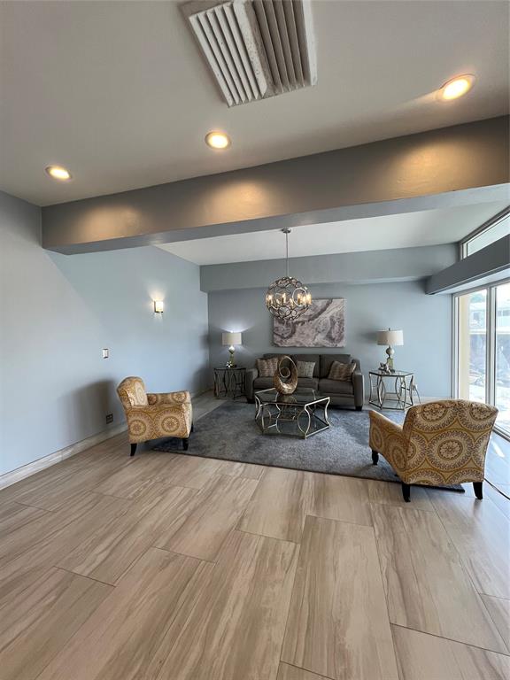 1200 Hibiscus Avenue, Unit 1501 Pompano Beach, FL 33062 - Photo 4 of 40 a living room with furniture and a chandelier