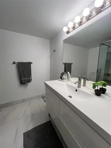 a bathroom with a double vanity sink and a mirror