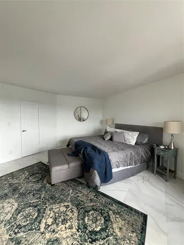 a bedroom with bed and window