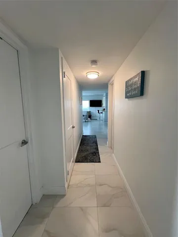 a hallway view with large mirror and window