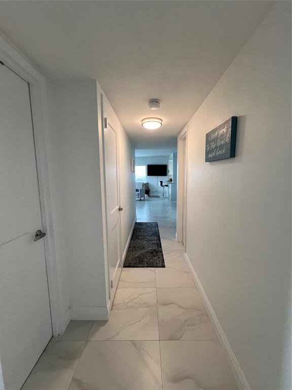 1200 Hibiscus Avenue, Unit 1501 Pompano Beach, FL 33062 - Photo 9 of 40 a hallway view with large mirror and window