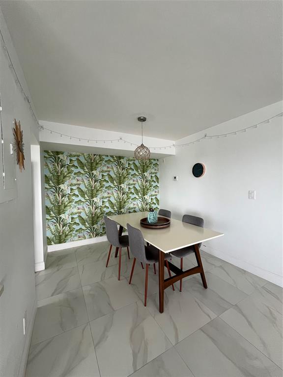 1200 Hibiscus Avenue, Unit 1501 Pompano Beach, FL 33062 - Photo 10 of 40 a dining room with furniture and window