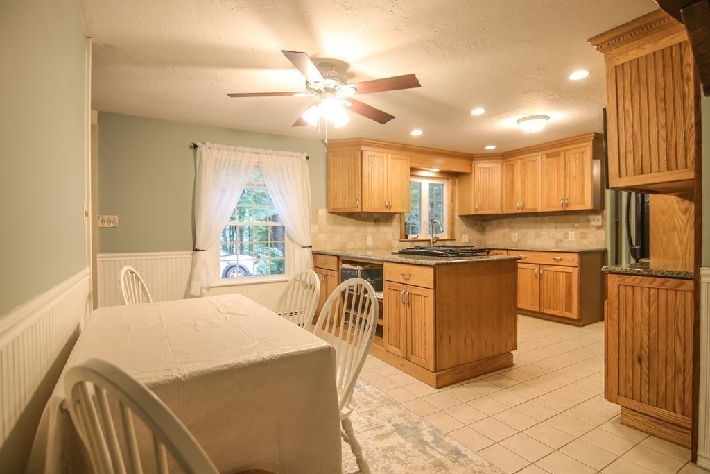 69 John Gilbert Road West Brookfield, MA 01585 - Photo 11 of 41 a kitchen with kitchen island granite countertop a sink a counter top space appliances and cabinets