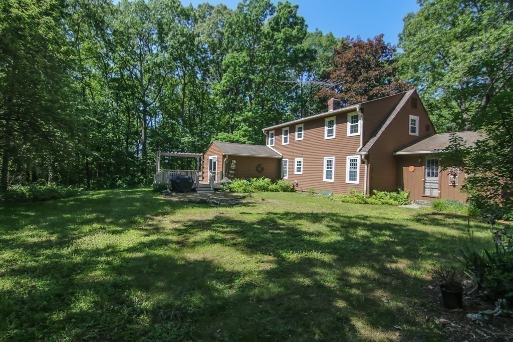 69 John Gilbert Road West Brookfield, MA 01585 - Photo 28 of 41 a front view of a house with a yard and trees