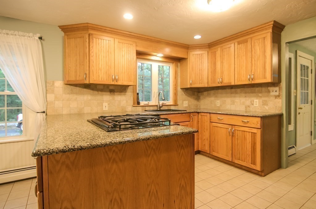 69 John Gilbert Road West Brookfield, MA 01585 - Photo 10 of 41 a kitchen with stainless steel appliances granite countertop a stove a sink and a refrigerator
