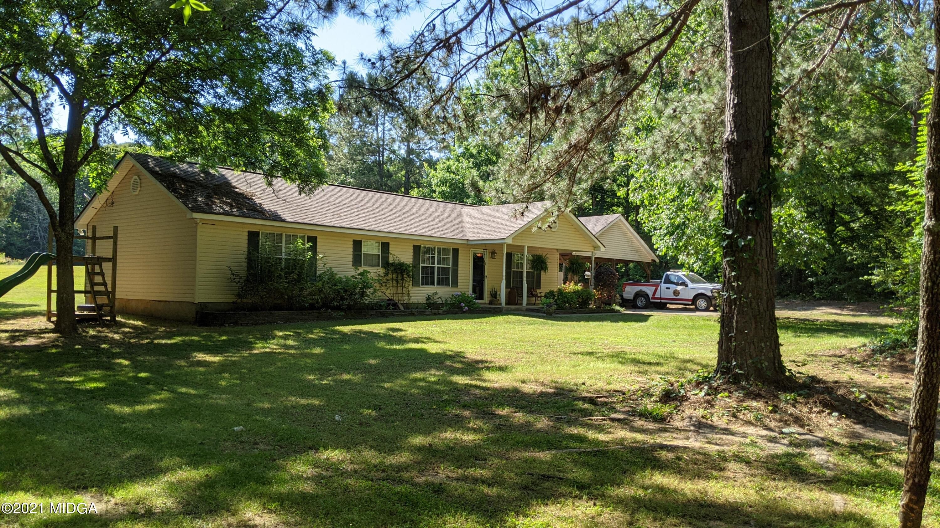 140 Rock Springs Road Milner, GA 30257 - Photo 1 of 15 a front view of a house with a garden