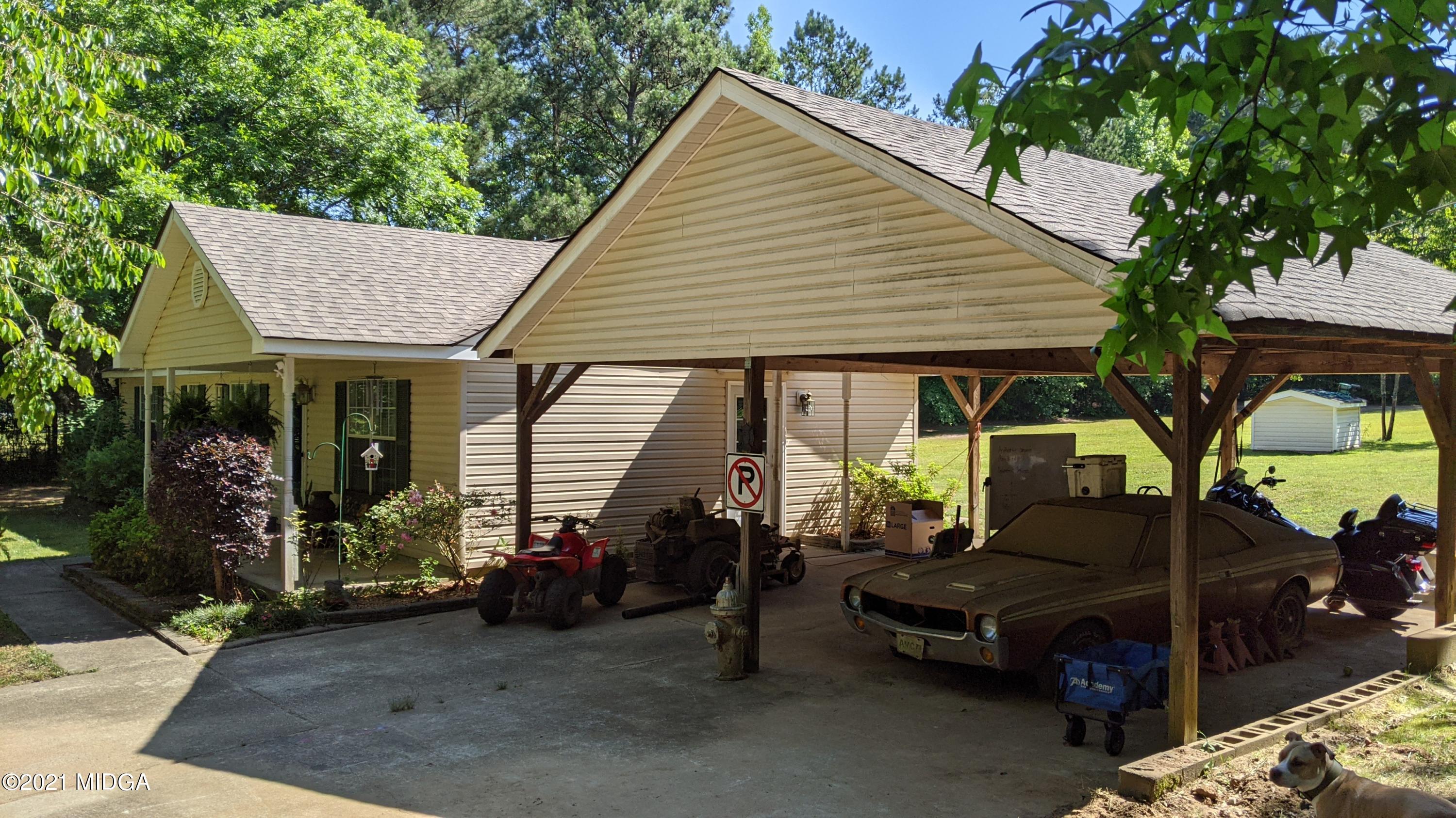 140 Rock Springs Road Milner, GA 30257 - Photo 2 of 15 a view of a house with a patio and a yard