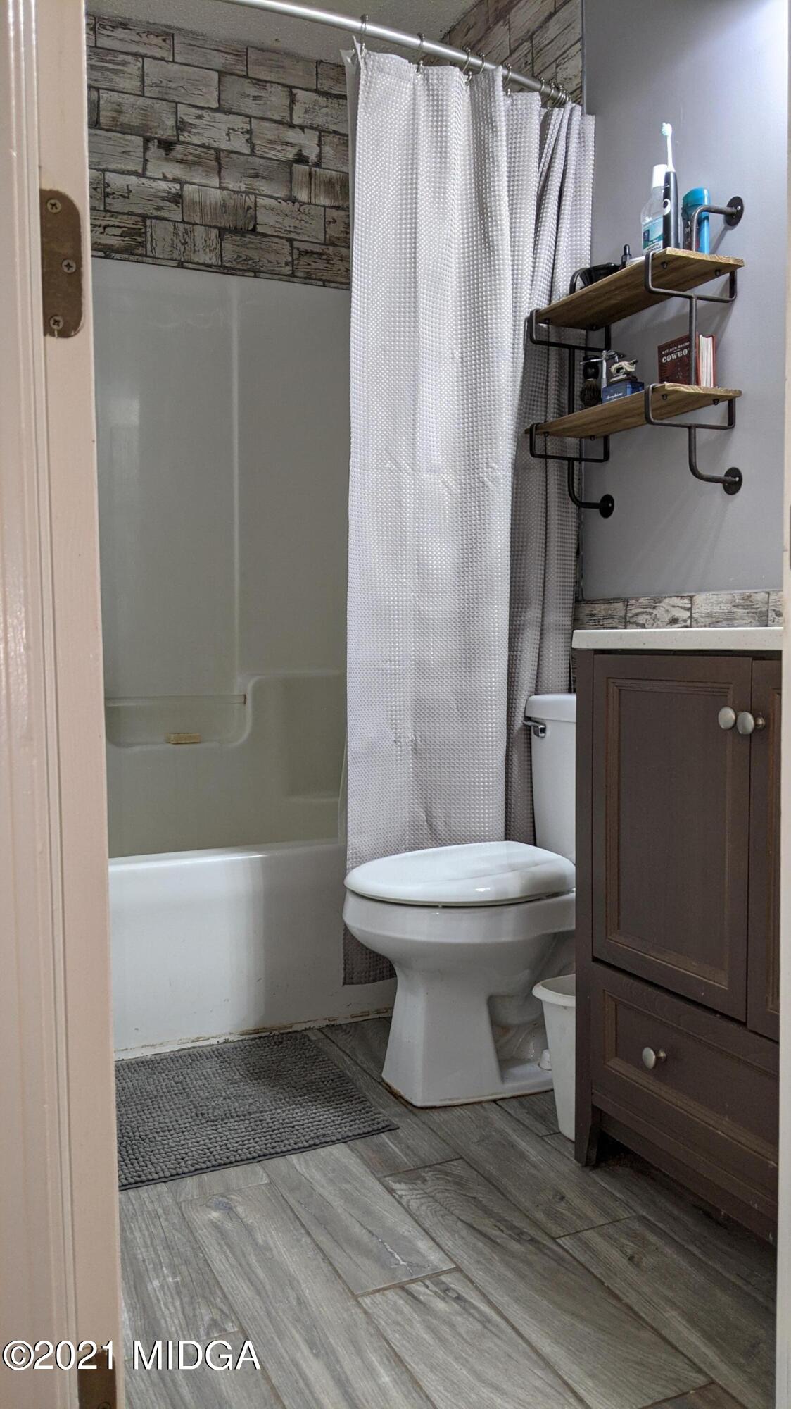 140 Rock Springs Road Milner, GA 30257 - Photo 11 of 15 a bathroom with a toilet and a shower