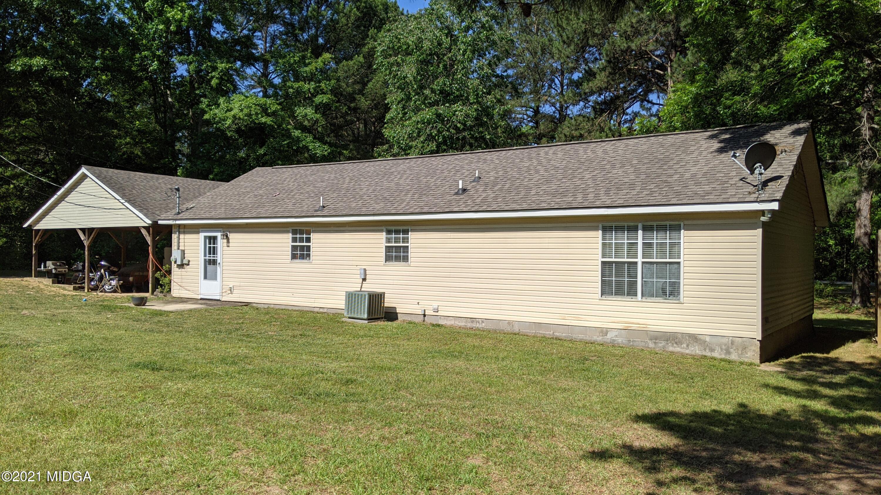 140 Rock Springs Road Milner, GA 30257 - Photo 13 of 15 a view of a house with a backyard