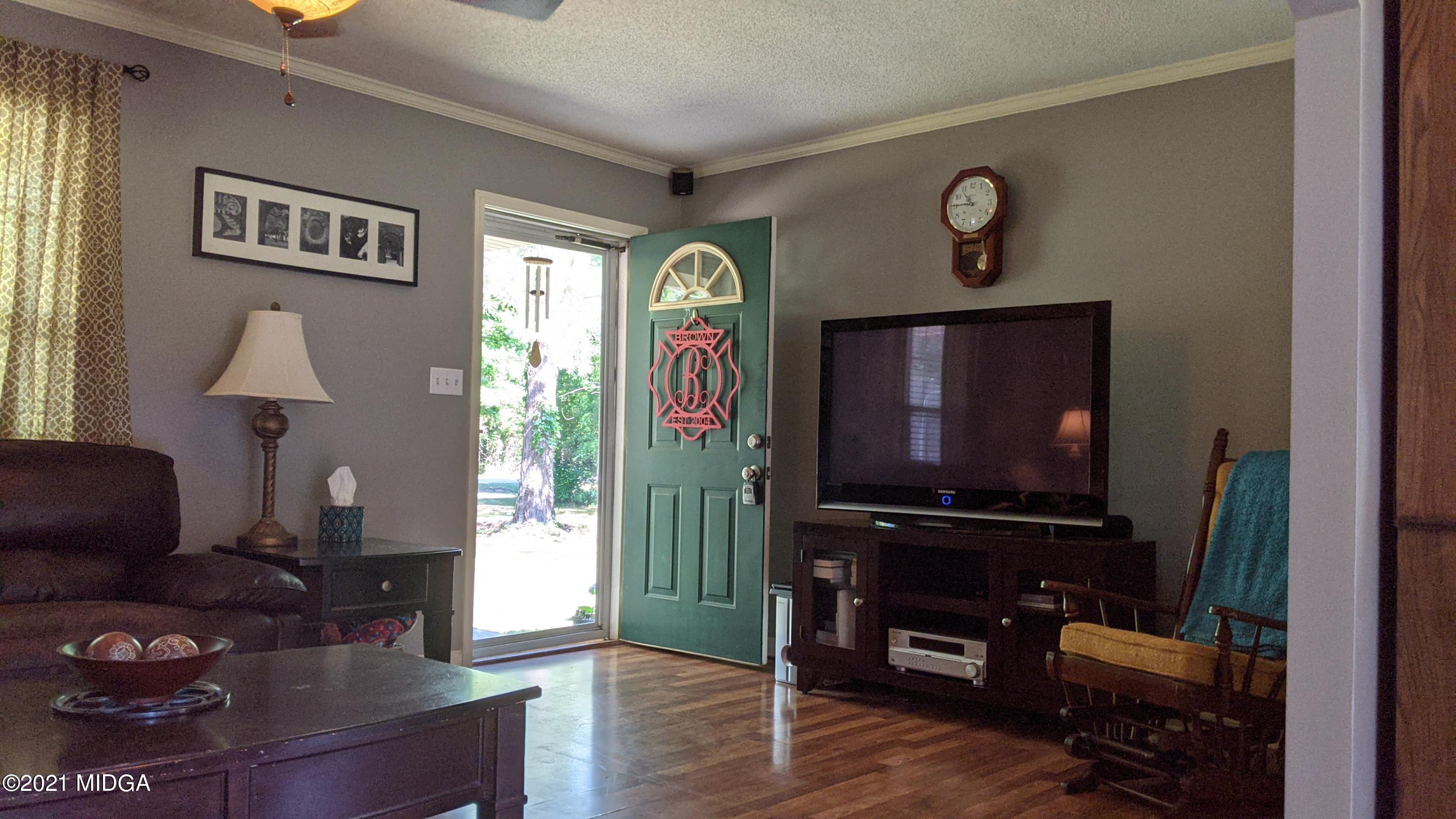 140 Rock Springs Road Milner, GA 30257 - Photo 3 of 15 a living room with furniture and a flat screen tv
