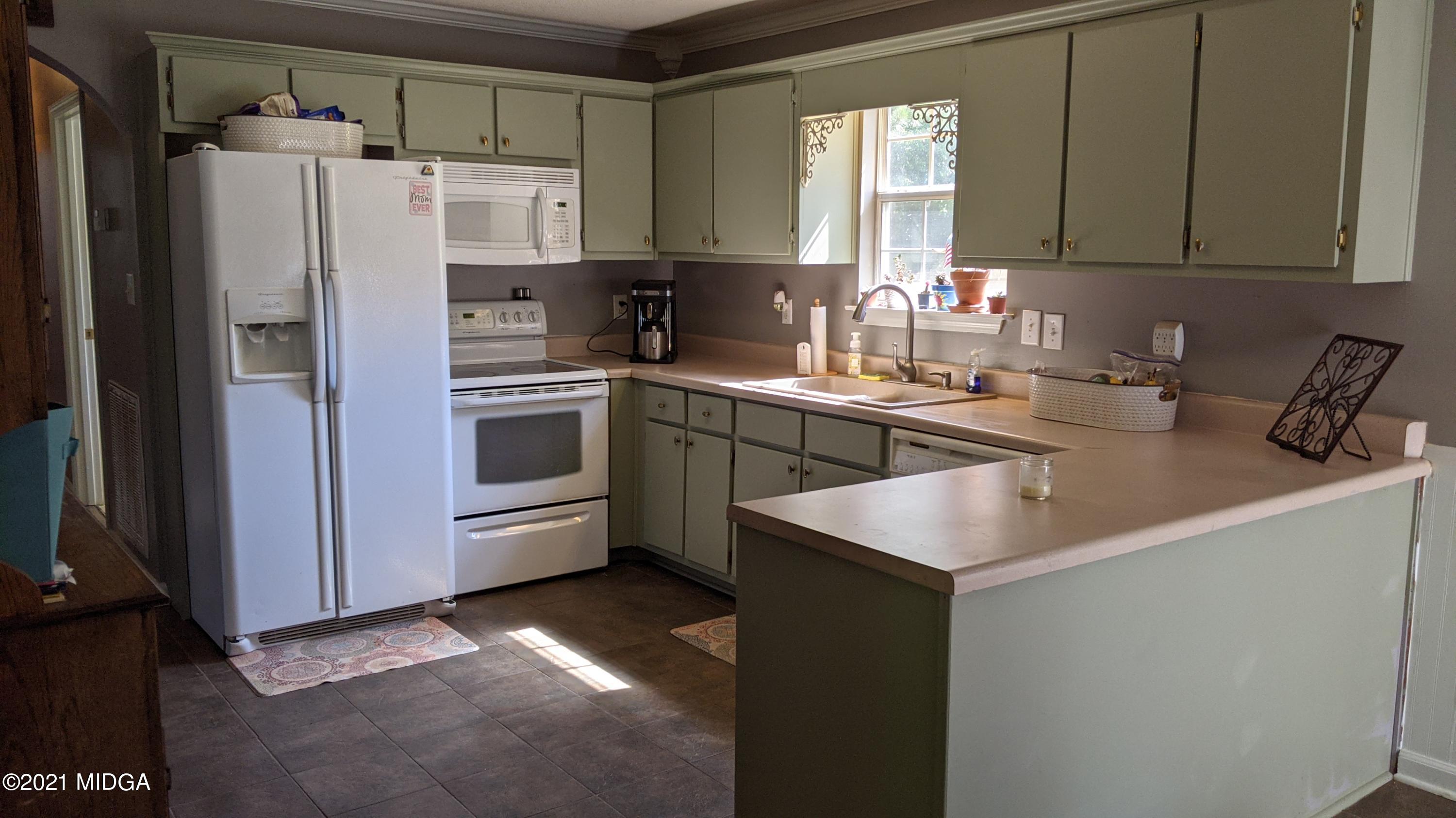 140 Rock Springs Road Milner, GA 30257 - Photo 5 of 15 a kitchen that has a sink cabinets and stainless steel appliances