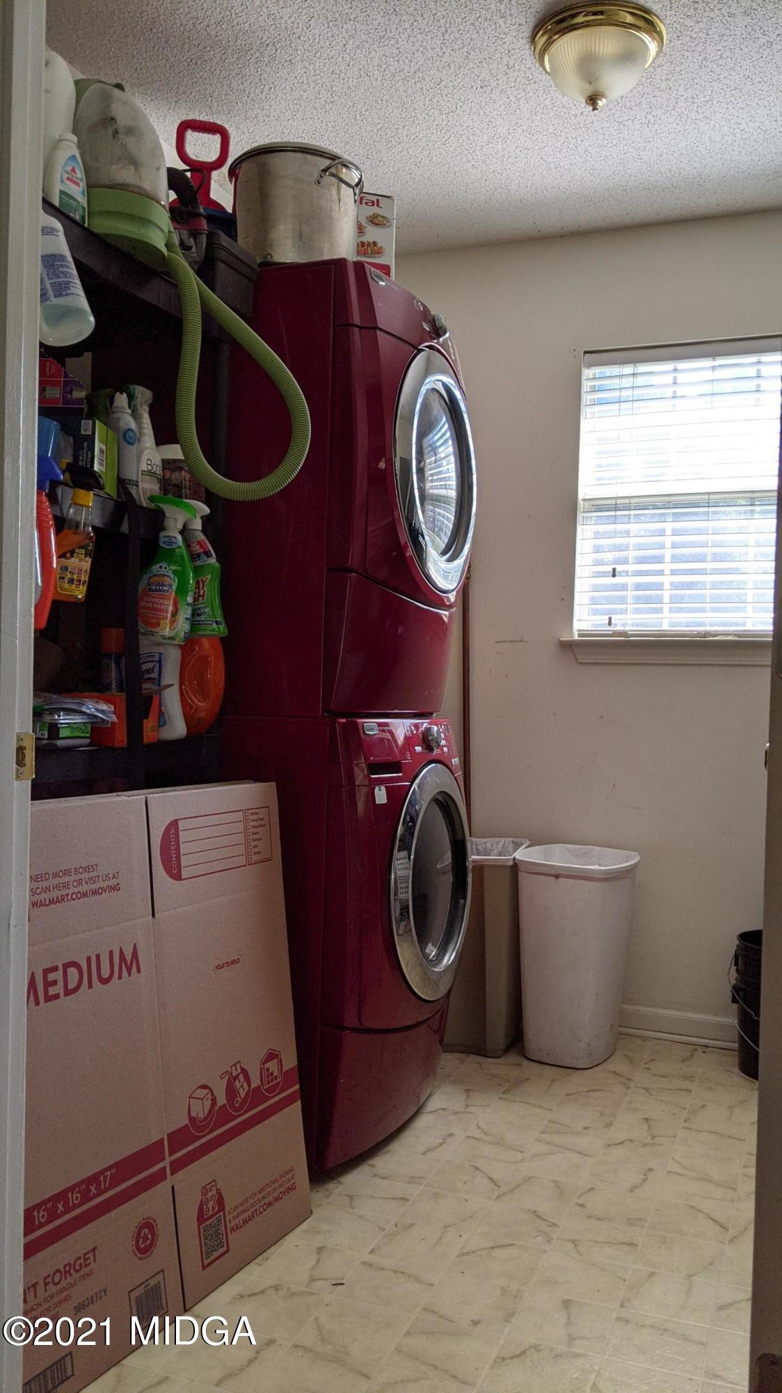 140 Rock Springs Road Milner, GA 30257 - Photo 7 of 15 a room with a washing machine and a mirror