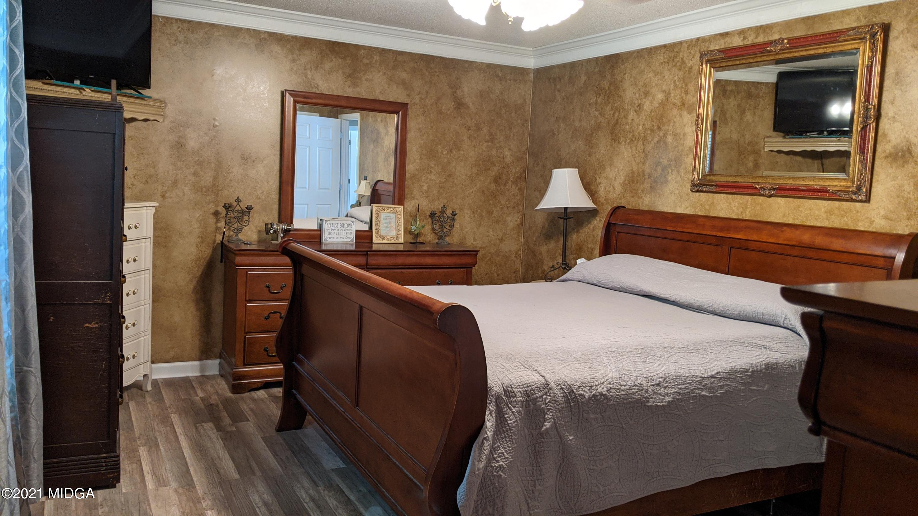 140 Rock Springs Road Milner, GA 30257 - Photo 8 of 15 a bedroom with a bed and a mirror