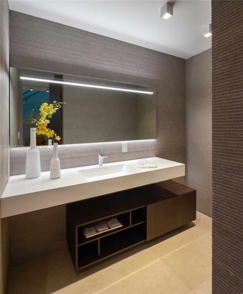 1234 South Biscayne Point Road Miami Beach, FL 33141 - Photo 17 of 30 a bathroom with a sink and a mirror