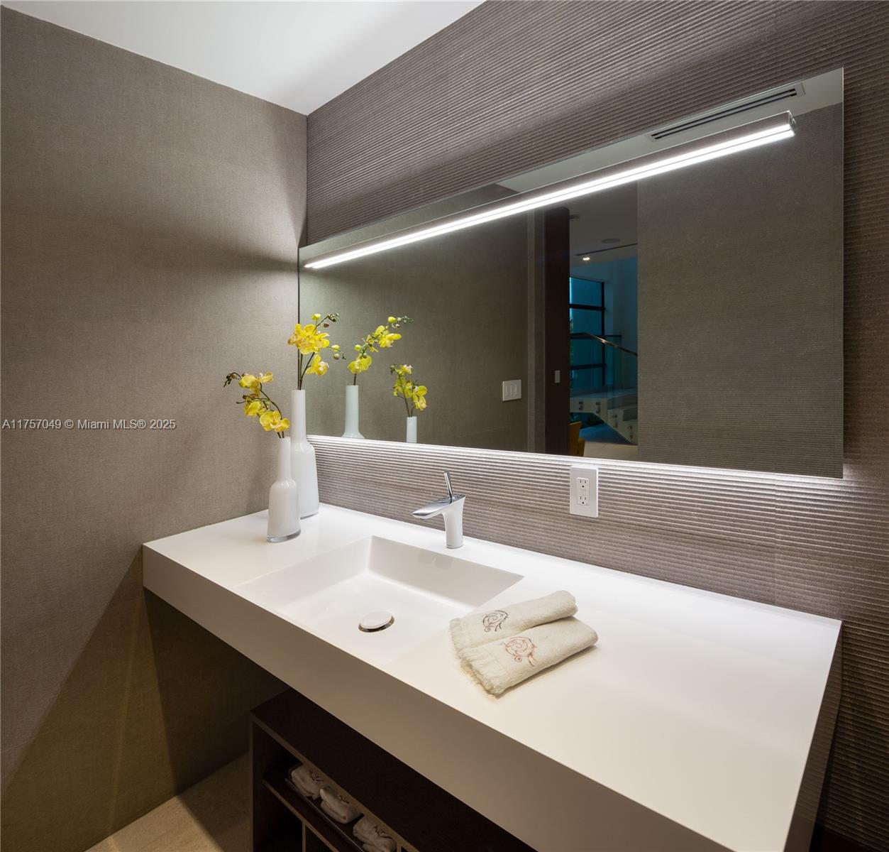 1234 South Biscayne Point Road Miami Beach, FL 33141 - Photo 18 of 30 a bathroom with a sink and a mirror