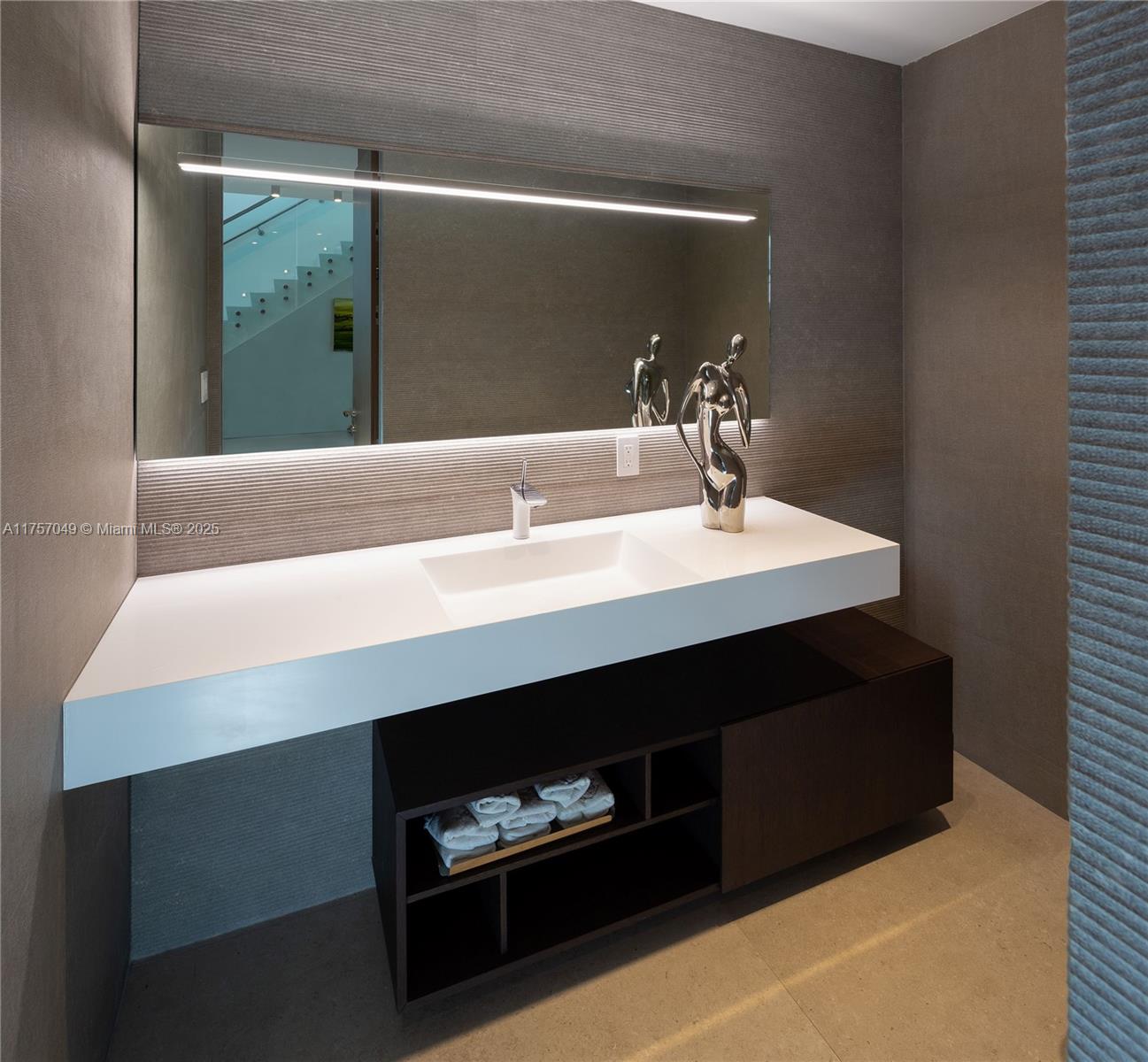 1234 South Biscayne Point Road Miami Beach, FL 33141 - Photo 21 of 30 a bathroom with a sink a vanity and a mirror