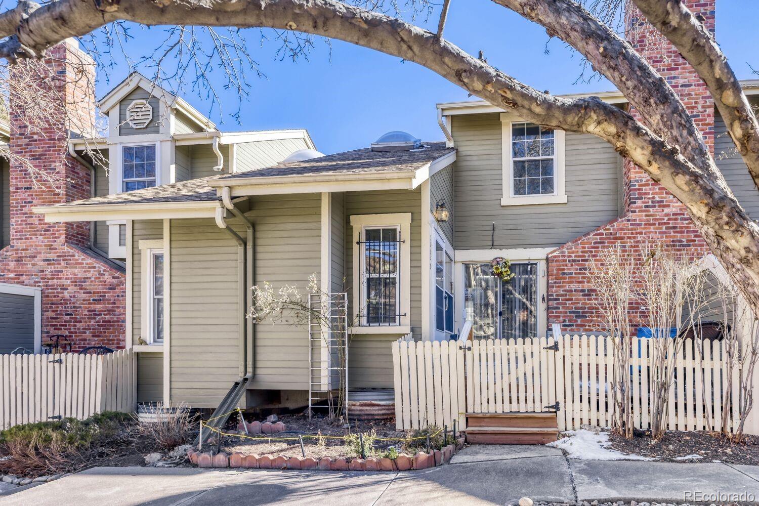 a front view of a house with wooden fence