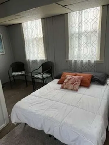 a bedroom with a bed and a window