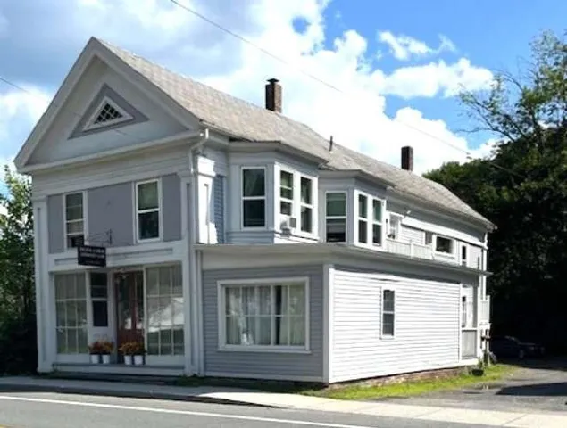 a view of a white building among the street