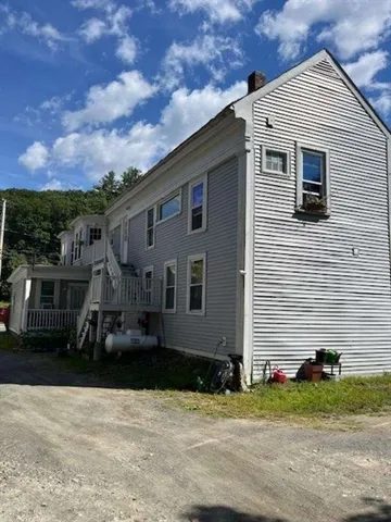 a view of a backyard with sitting area