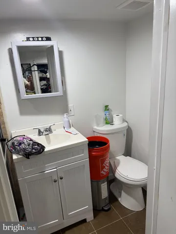 a bathroom with a sink toilet and mirror