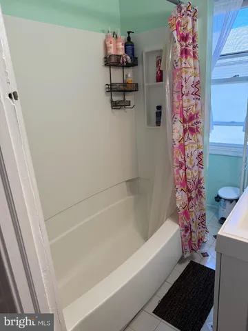 a bathroom with a bathtub and shower