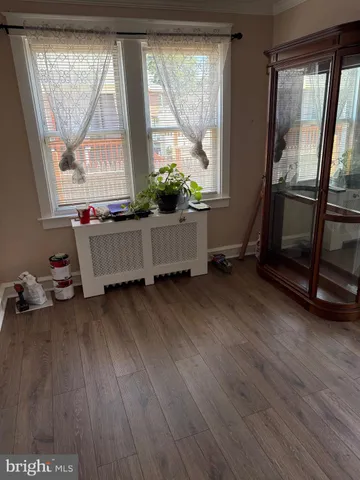 a room with wooden floor and a window