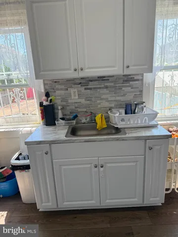 a kitchen with a sink a stove and cabinets