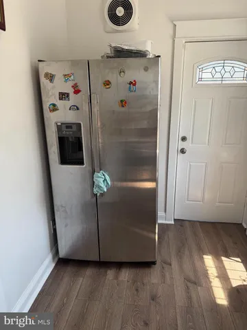 a view of a hallway with wooden floor and closet