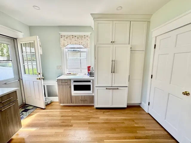 a view of a kitchen with wooden floor