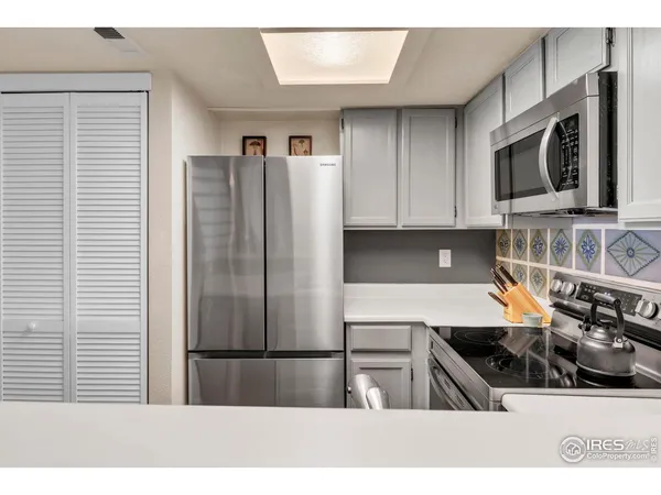 a kitchen with stainless steel appliances a refrigerator a sink a stove and cabinets