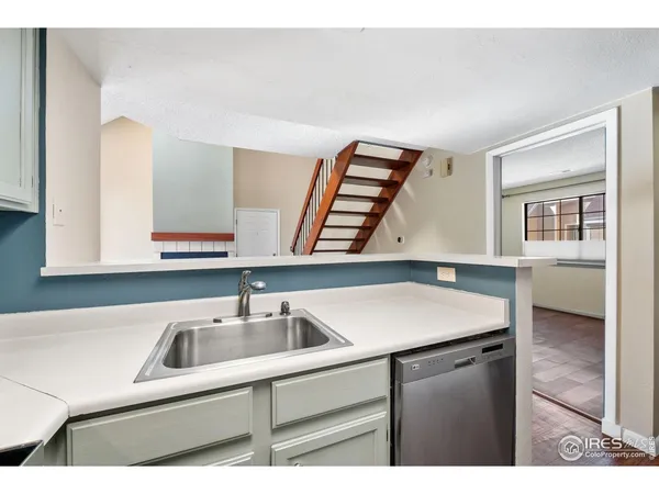 a kitchen with a sink cabinets and a window