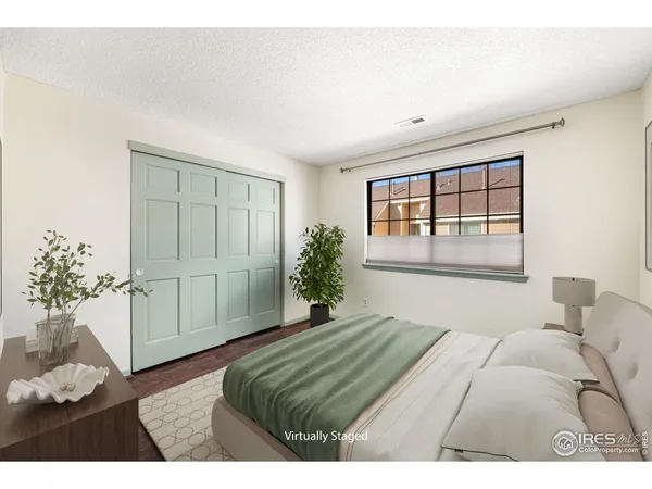 a bedroom with a large bed and a potted plant