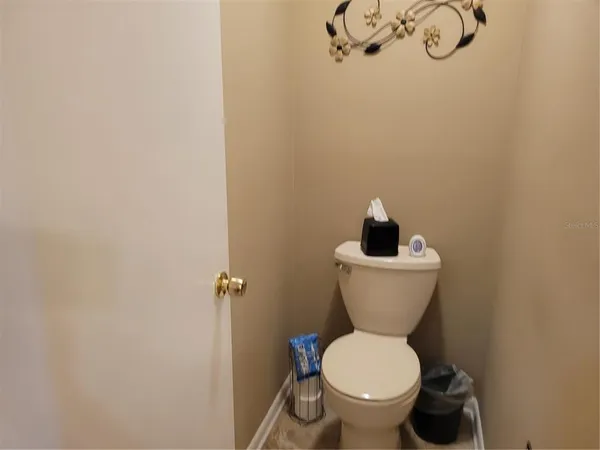 a bathroom with a toilet and a vanity