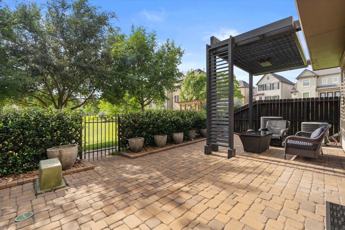 10215 Spring Shadows Park Circle Houston, TX 77080 - Photo 37 of 44 Pavers added and all usable space. Access gate to the green space and walking trails.