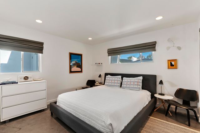 a bedroom with a bed and a desk