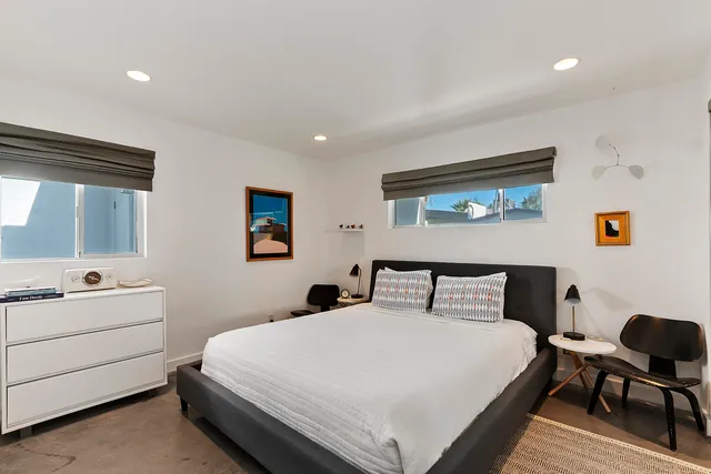 a bedroom with a bed and a desk