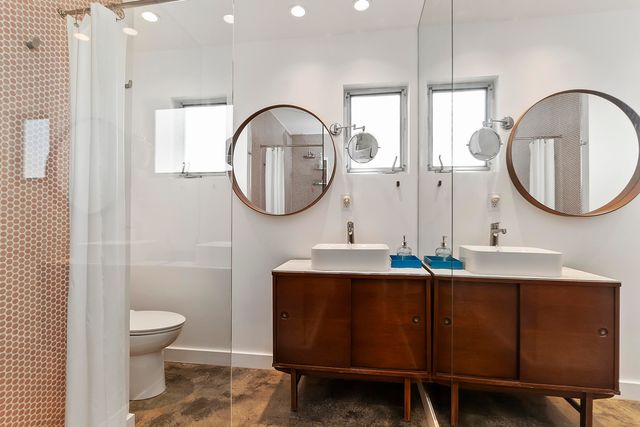 a bathroom with a toilet a sink and a mirror