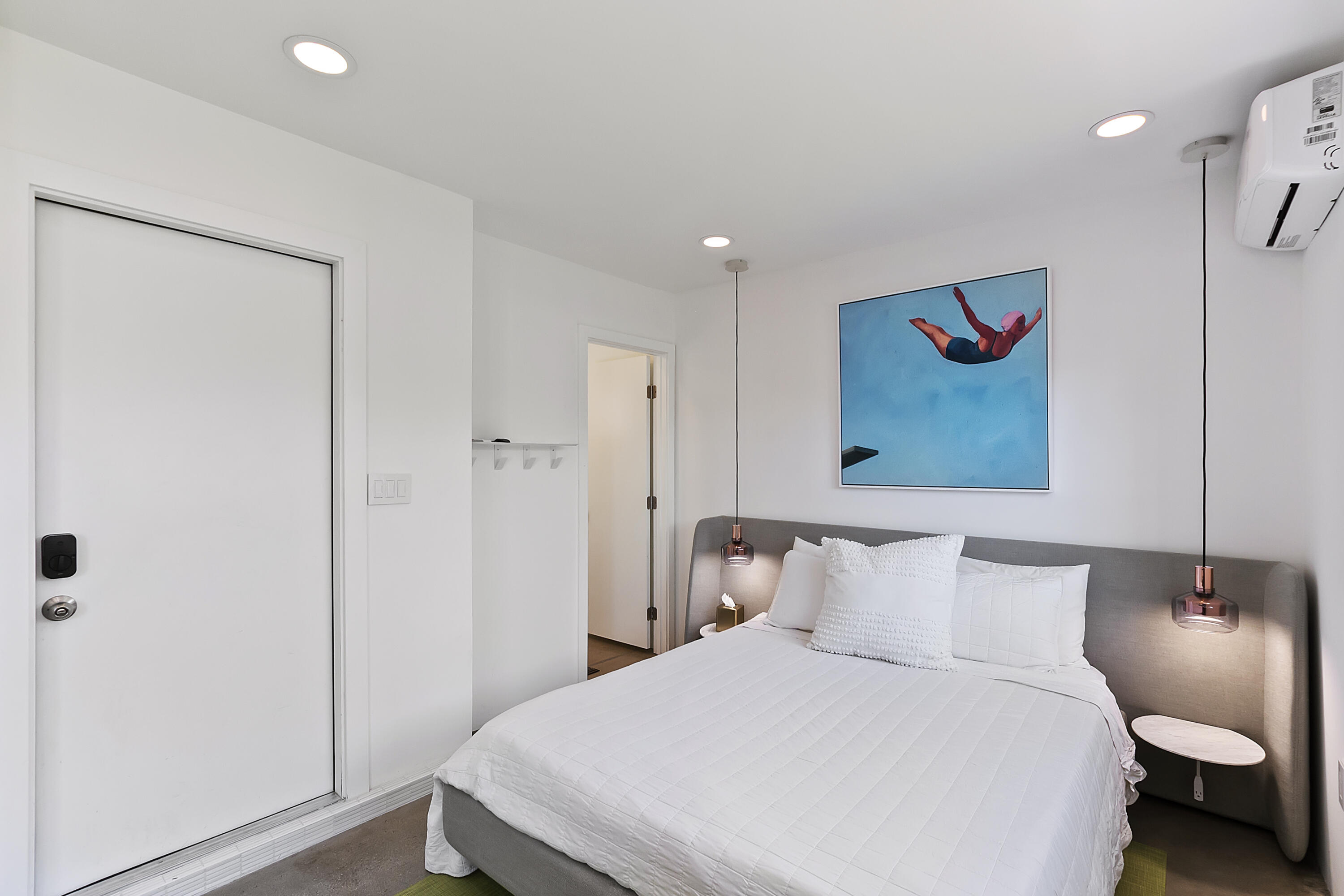 45876 Abronia Trail Palm Desert, CA 92260 - Photo 16 of 26 a bedroom with a bed and a painting on the wall