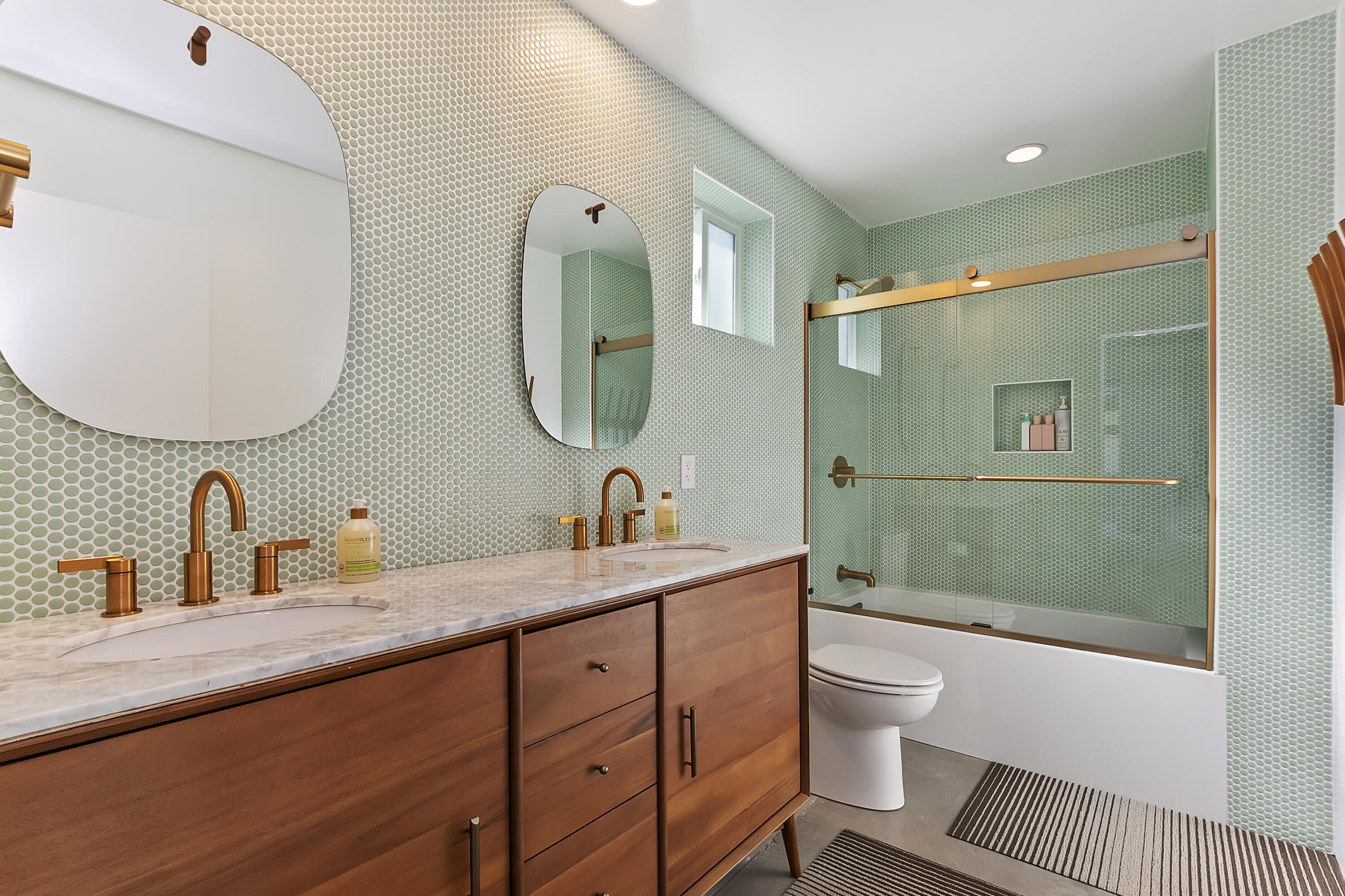 45876 Abronia Trail Palm Desert, CA 92260 - Photo 17 of 26 a spacious bathroom with a double vanity sink toilet mirror and shower