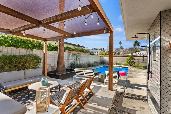 an outdoor space with seating area and glass door