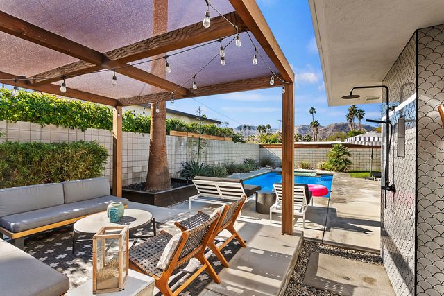 an outdoor space with seating area and glass door