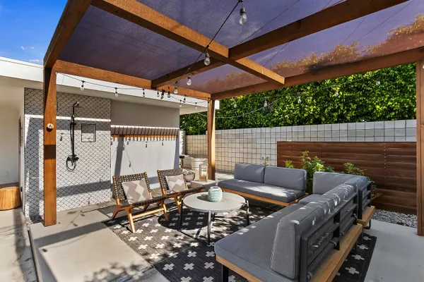 a view of an outdoor sitting area with furniture and umbrella